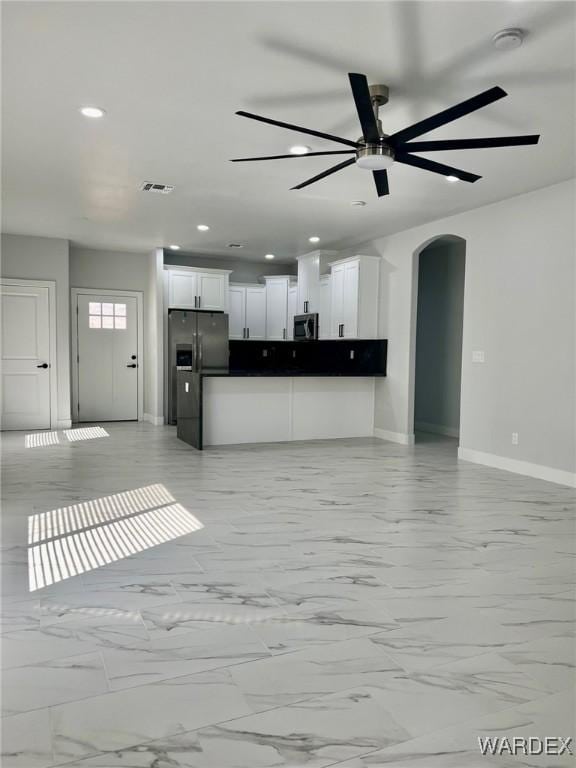 kitchen with stainless steel appliances, visible vents, white cabinets, open floor plan, and dark countertops