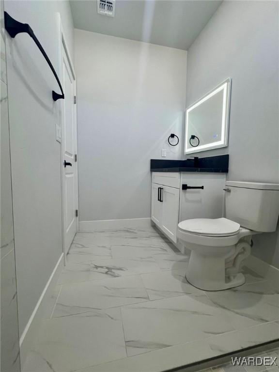 bathroom featuring baseboards, visible vents, toilet, marble finish floor, and vanity