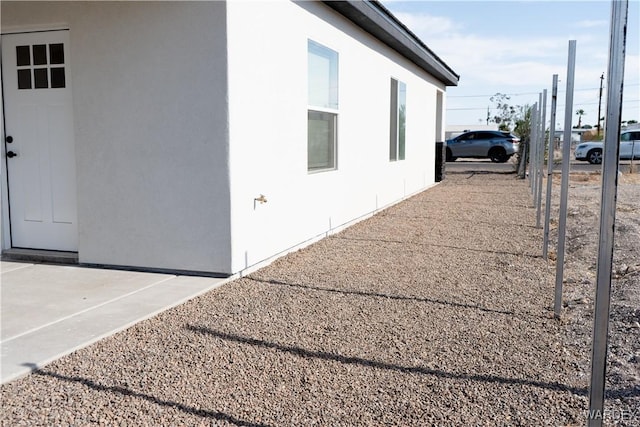 view of side of home with stucco siding