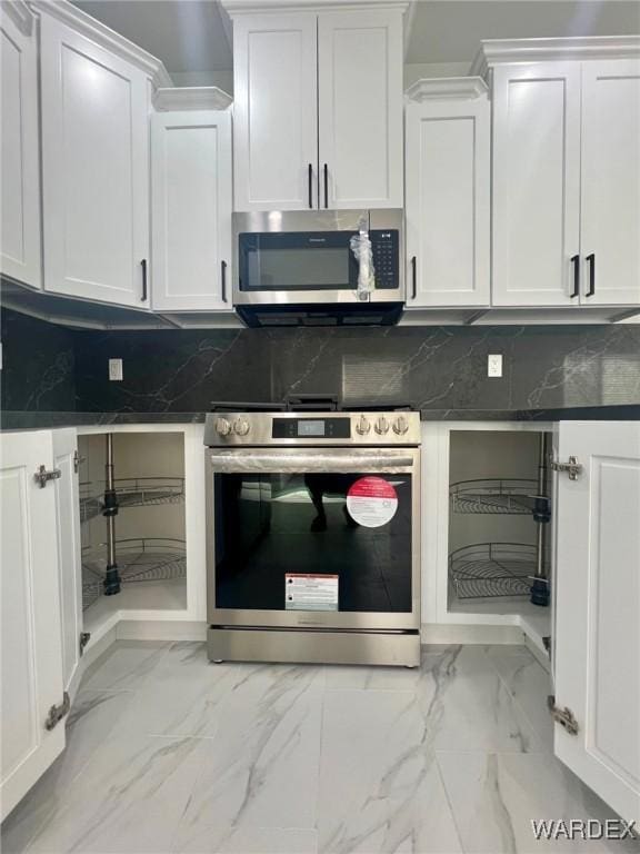 kitchen with marble finish floor, white cabinetry, stainless steel appliances, and decorative backsplash