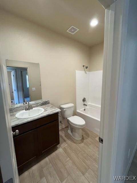 bathroom featuring washtub / shower combination, visible vents, vanity, and toilet