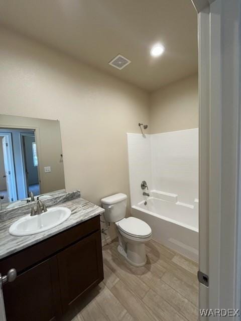 full bath with toilet, washtub / shower combination, visible vents, and vanity