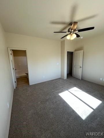 unfurnished bedroom featuring a ceiling fan and dark colored carpet