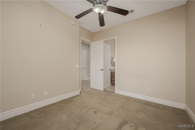 unfurnished bedroom featuring light colored carpet, visible vents, baseboards, and ensuite bathroom