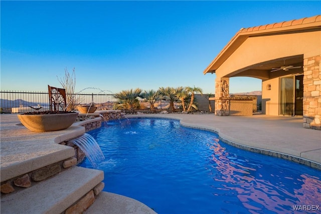 view of swimming pool featuring ceiling fan, a fenced backyard, and a fenced in pool