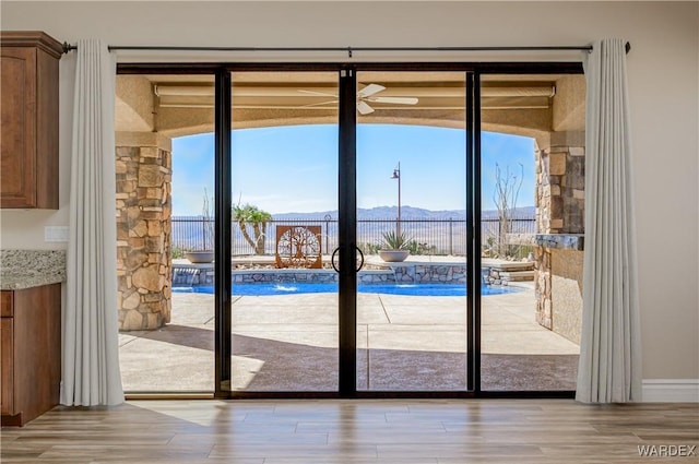 entryway with light wood-style floors and a mountain view