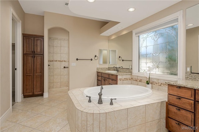 full bath featuring a garden tub, visible vents, vanity, a tile shower, and tile patterned floors