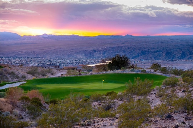 exterior space with view of golf course and a mountain view