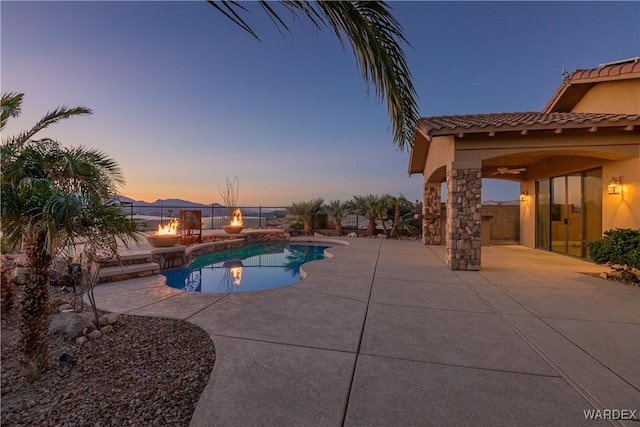 view of pool with a patio, fence, a fenced in pool, and a ceiling fan