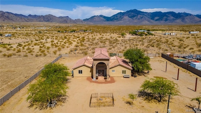 drone / aerial view featuring a desert view and a mountain view