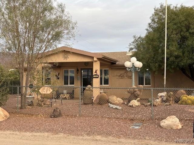 view of front of home featuring a fenced front yard and stucco siding