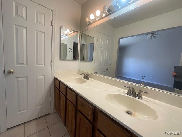 full bathroom with double vanity, tile patterned flooring, and a sink