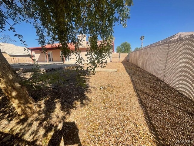 view of yard with a fenced backyard and a patio