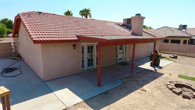 back of house featuring central AC, fence, french doors, stucco siding, and a patio area