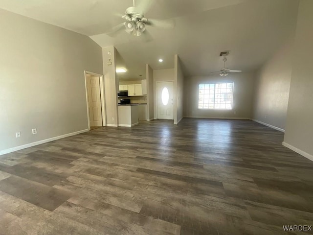 unfurnished living room with dark wood finished floors, lofted ceiling, visible vents, a ceiling fan, and baseboards