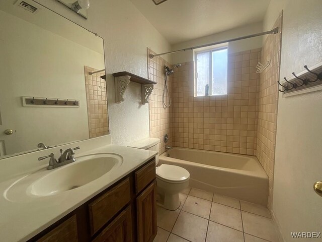 bathroom featuring toilet, shower / bath combination, vanity, visible vents, and tile patterned floors