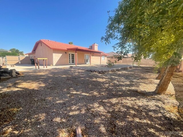 back of property featuring a fenced backyard and stucco siding