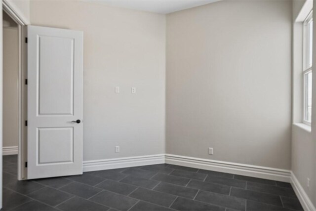 6068 S Greenhorn Dr, Fort Mohave, AZ 86426 - spare room with baseboards and dark tile patterned floors