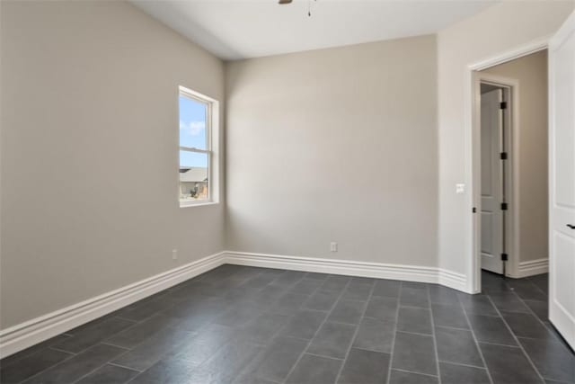 6068 S Greenhorn Dr, Fort Mohave, AZ 86426 - spare room featuring a ceiling fan, baseboards, and dark tile patterned flooring