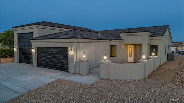 6068 S Greenhorn Dr, Fort Mohave, AZ 86426 - contemporary home featuring a garage, cooling unit, stucco siding, and concrete driveway