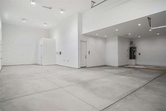 6068 S Greenhorn Dr, Fort Mohave, AZ 86426 - garage featuring water heater, baseboards, and recessed lighting