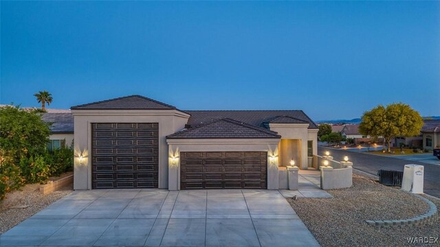 6068 S Greenhorn Dr, Fort Mohave, AZ 86426 - view of front of property with a garage, concrete driveway, and stucco siding