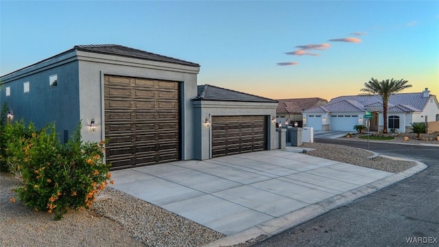 6068 S Greenhorn Dr, Fort Mohave, AZ 86426 - garage at dusk with driveway