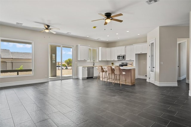 6068 S Greenhorn Dr, Fort Mohave, AZ 86426 - kitchen with a ceiling fan, appliances with stainless steel finishes, light countertops, white cabinetry, and recessed lighting