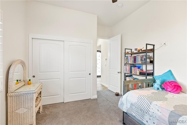 bedroom with arched walkways, a closet, and light colored carpet