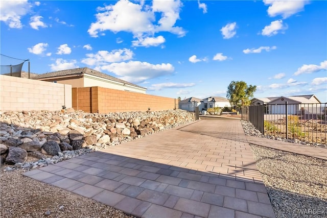 view of patio featuring fence private yard and a residential view