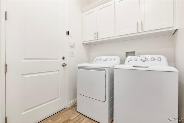 clothes washing area featuring cabinet space, light wood finished floors, and independent washer and dryer