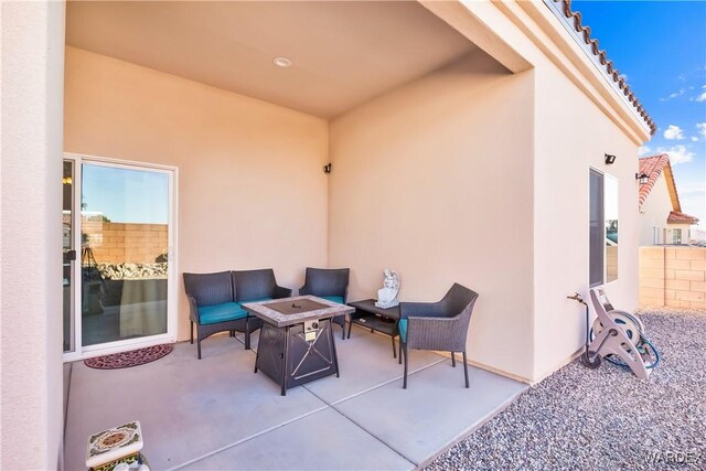 view of patio / terrace with an outdoor living space with a fire pit