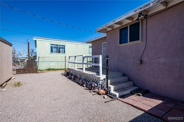 exterior space featuring a wooden deck and fence