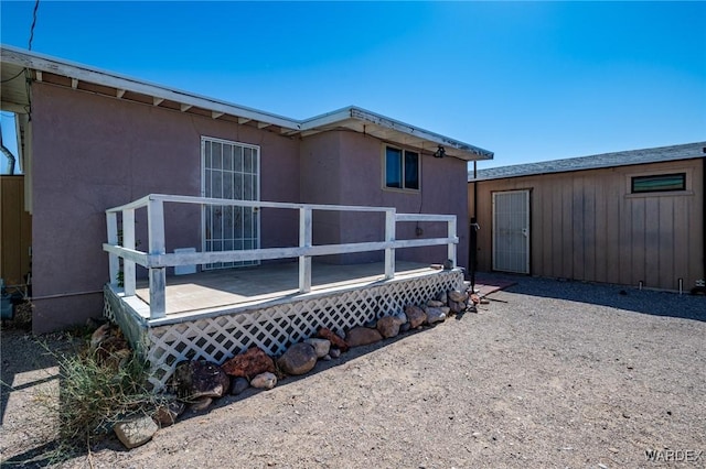 back of property with a wooden deck