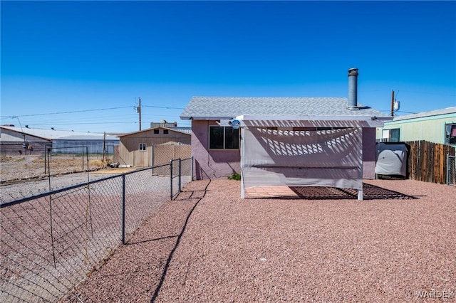 rear view of house with a pergola and fence