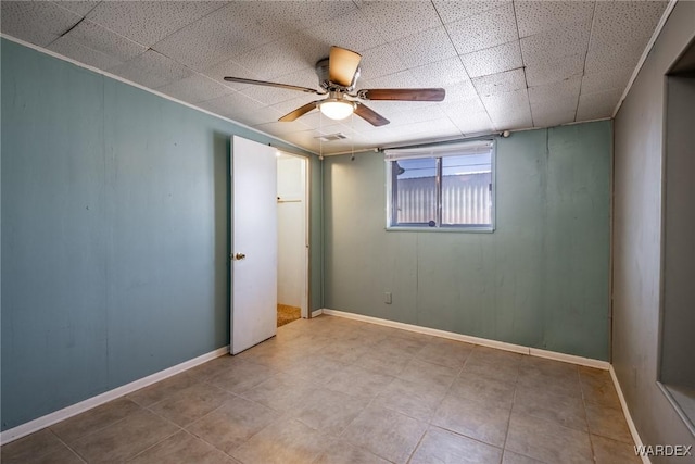 spare room featuring visible vents, baseboards, crown molding, and a ceiling fan