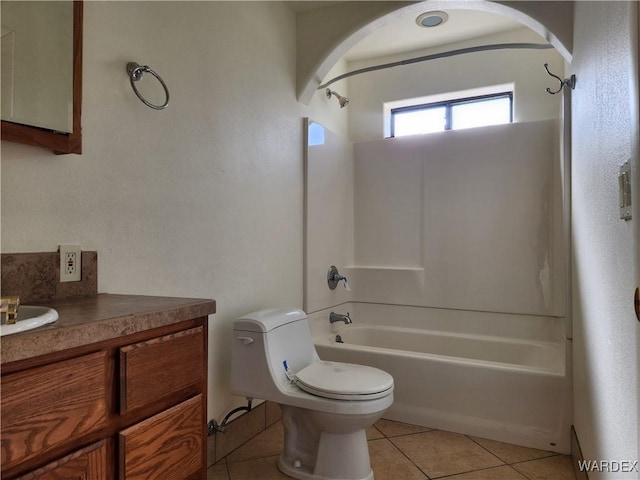 bathroom featuring toilet, bathing tub / shower combination, vanity, and tile patterned floors