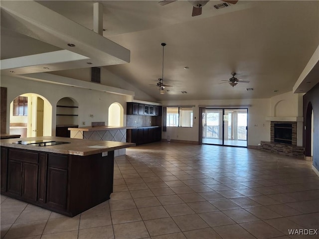 kitchen featuring a ceiling fan, open floor plan, light tile patterned floors, and black electric cooktop