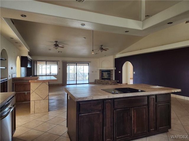 kitchen with a center island, open floor plan, ceiling fan, and black electric cooktop