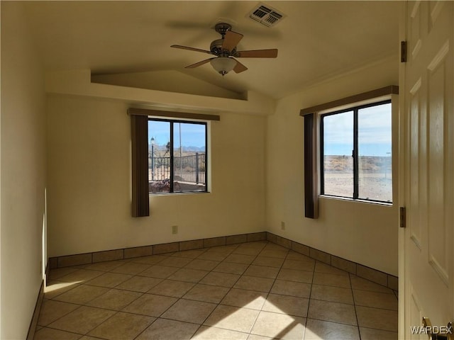 unfurnished room featuring light tile patterned floors, visible vents, ceiling fan, vaulted ceiling, and baseboards