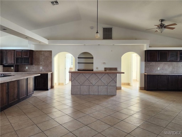 kitchen featuring dark brown cabinetry, visible vents, and light countertops