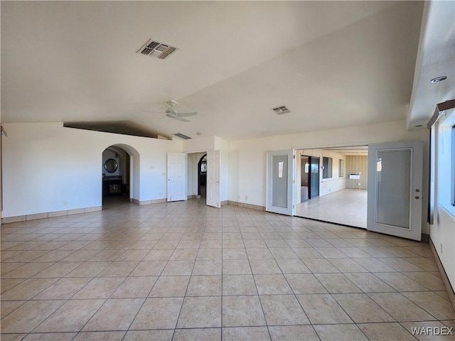 interior space with lofted ceiling, visible vents, a ceiling fan, and light tile patterned flooring