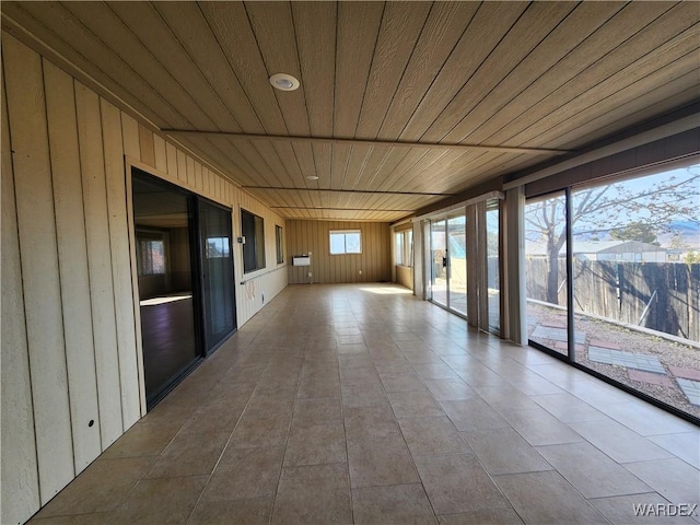 unfurnished sunroom with wood ceiling