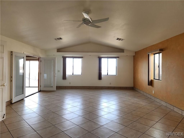 unfurnished room with lofted ceiling, light tile patterned floors, ceiling fan, and visible vents