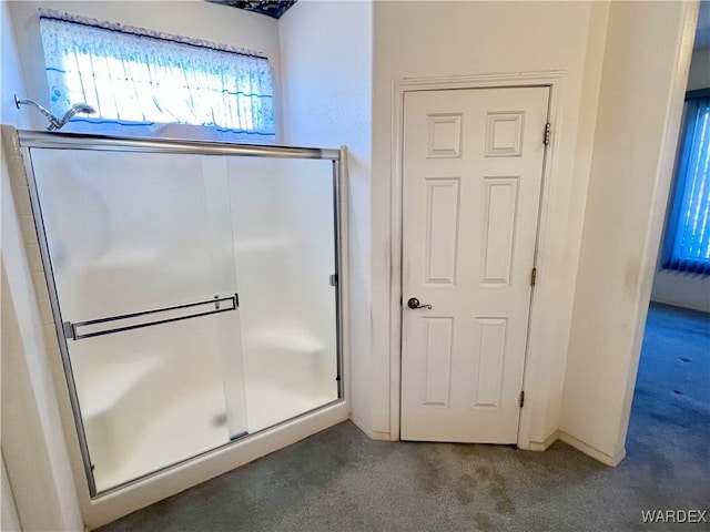 full bathroom featuring carpet and an enclosed shower