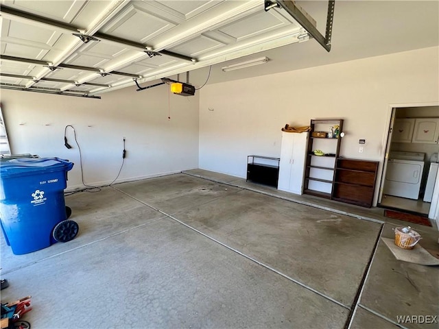 garage with a garage door opener and washer and clothes dryer