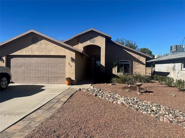 single story home featuring a garage, stucco siding, cooling unit, and driveway