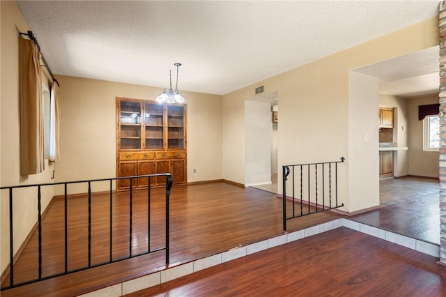 898 Crestwood Ln, Kingman, AZ 86409 - empty room featuring wood finished floors and a chandelier