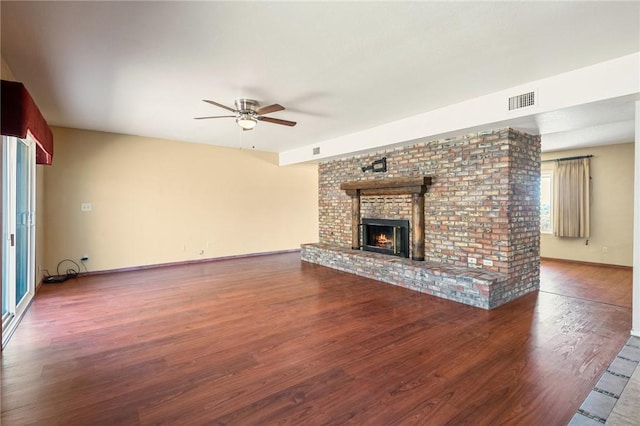 898 Crestwood Ln, Kingman, AZ 86409 - unfurnished living room with ceiling fan, wood finished floors, and a brick fireplace
