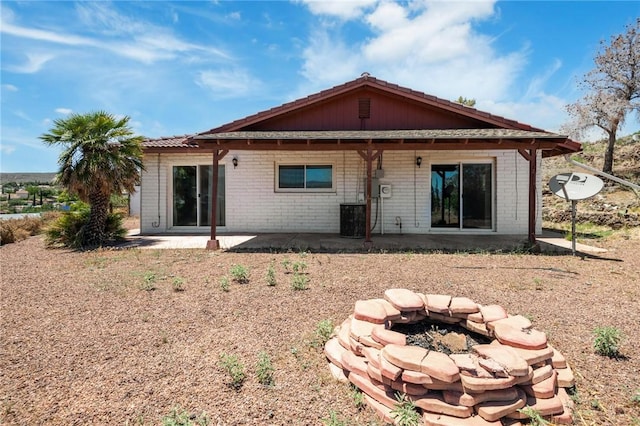 898 Crestwood Ln, Kingman, AZ 86409 - rear view of property with brick siding, a patio, and an outdoor fire pit